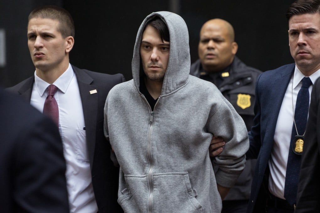 Martin Shkreli is led away from his New York apartment by federal agents on Thursday morning, after his arrest on fraud charges. Photo: AP