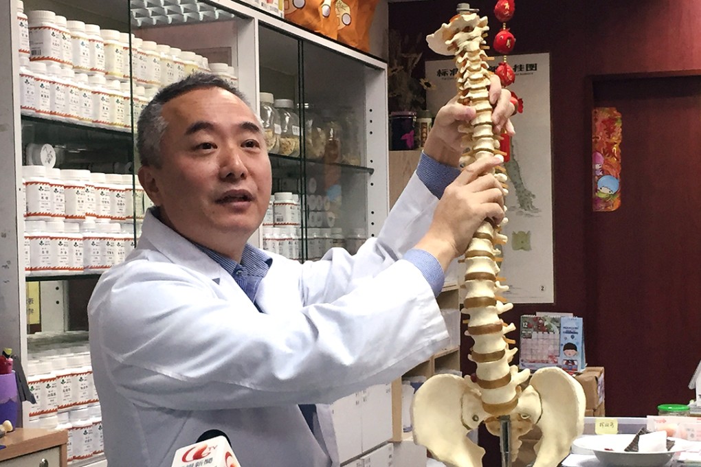 Chinese medicine practitioner Lam Chung explains tradition treatments for scoliosis. Photo: SCMP Pictures