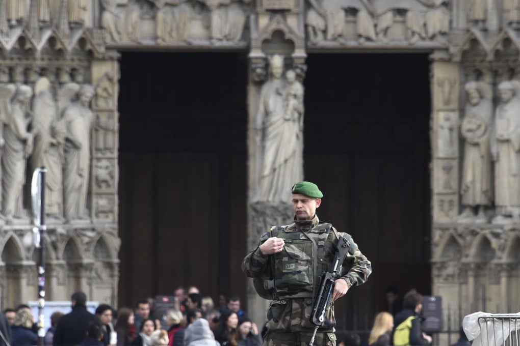 A soldier on patrol at the Notre-Dame de Paris cathedral on Christmas Eve. Photos: AFP; Corbis