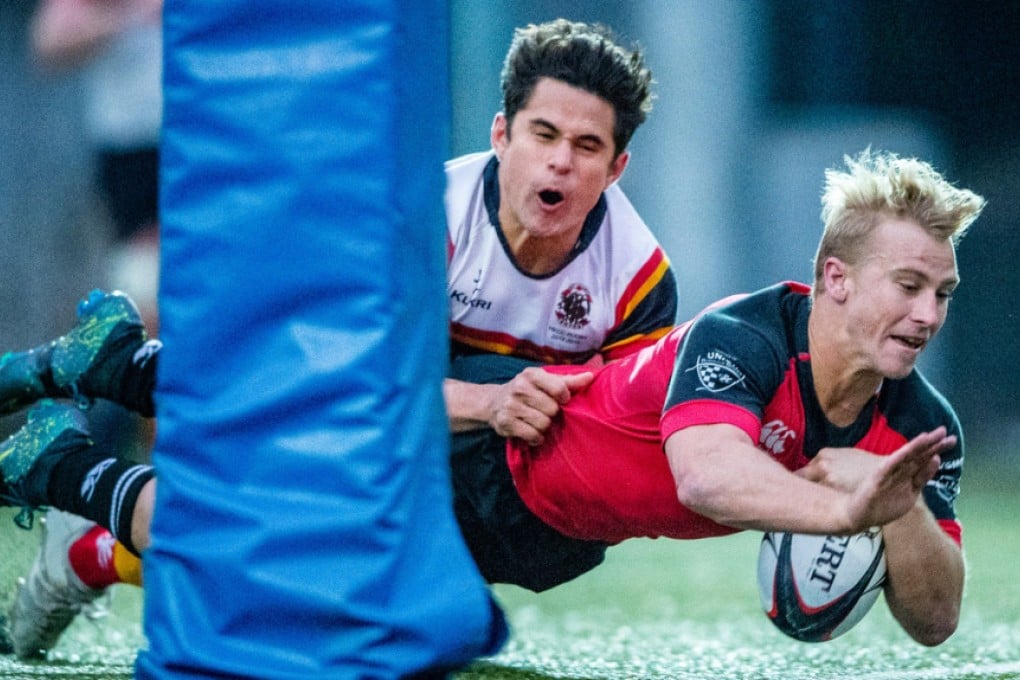 Max Woodward brushes past Rowan Varty to score one of seven Valley tries in a 45-10 romp over HKCC at Sandy Bay on Saturday. Photos: HKRU