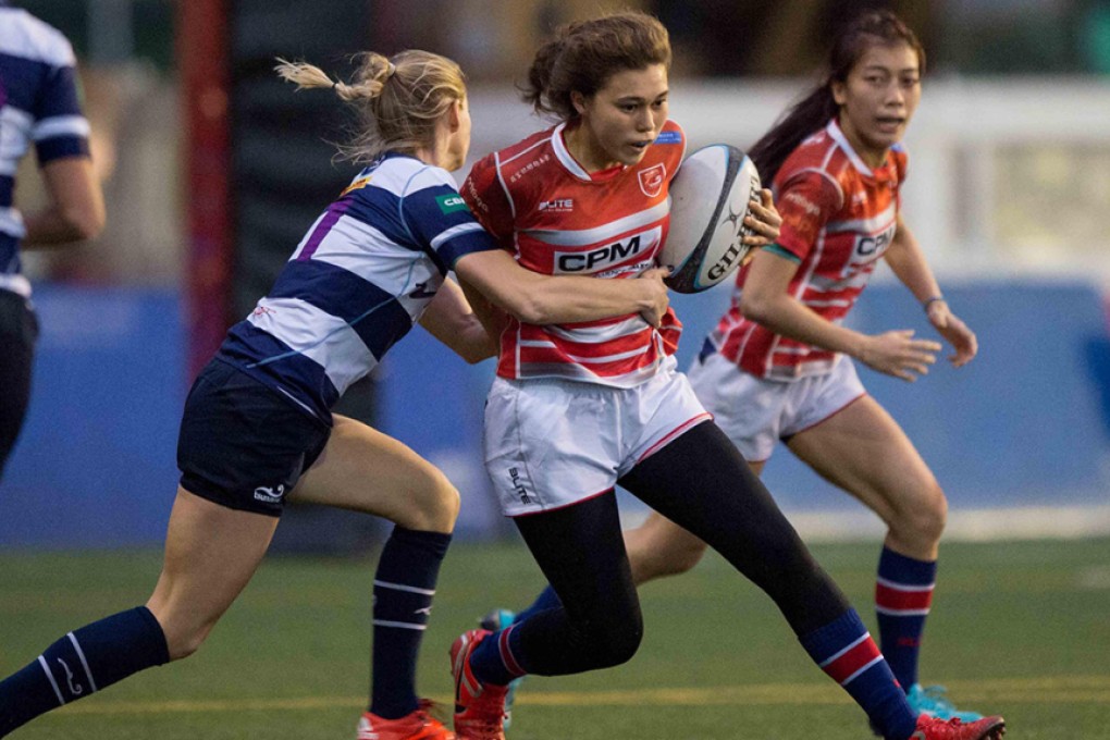 Teen stand-out Lucy Ross carries the ball into battle before scoring her first try for Gai Wu Falcons in a 17-0 triumph over HKFC Ice on Saturday. Photos: HKRU