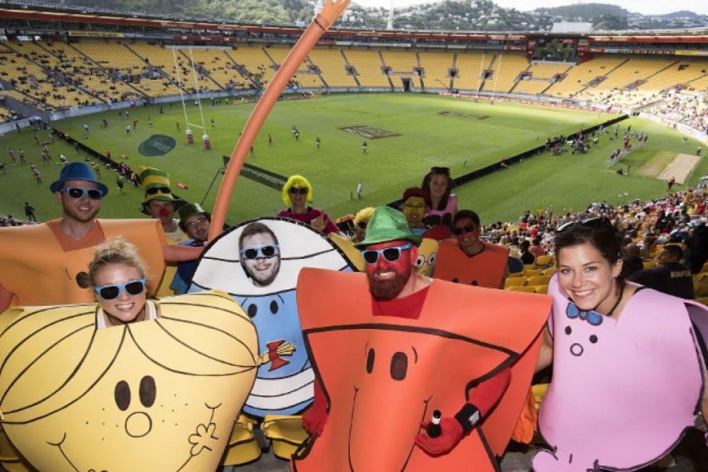 Spectators pose in a near-empty WestPac Stadium on Saturday at the 2016 Wellington Sevens. Photo: AFP