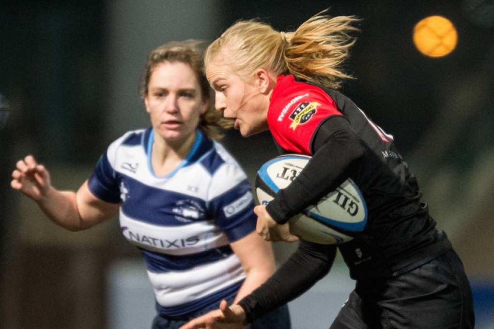 Adrienne Garvey of valley Black Ladies looks for a gap in the HKFC defence last month. Photos: HKRU