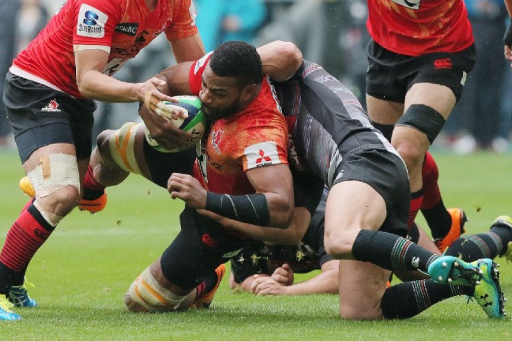 Andrew Durutalo of Japan’s new Super Rugby franchise the Sunwolves is tackled during a charity match against a Top League select side in Toyota, Japan. Photo: AFP