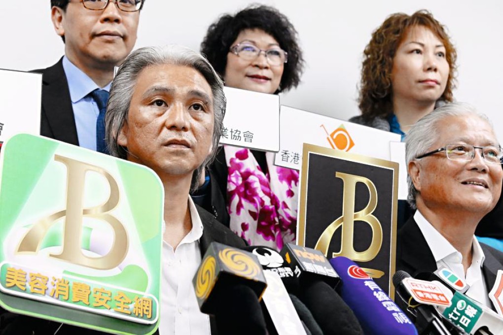 Federation of Beauty Industry chairman Nelson Ip Sai-hung, left, launches the quality services scheme. Photo: Dickson Lee