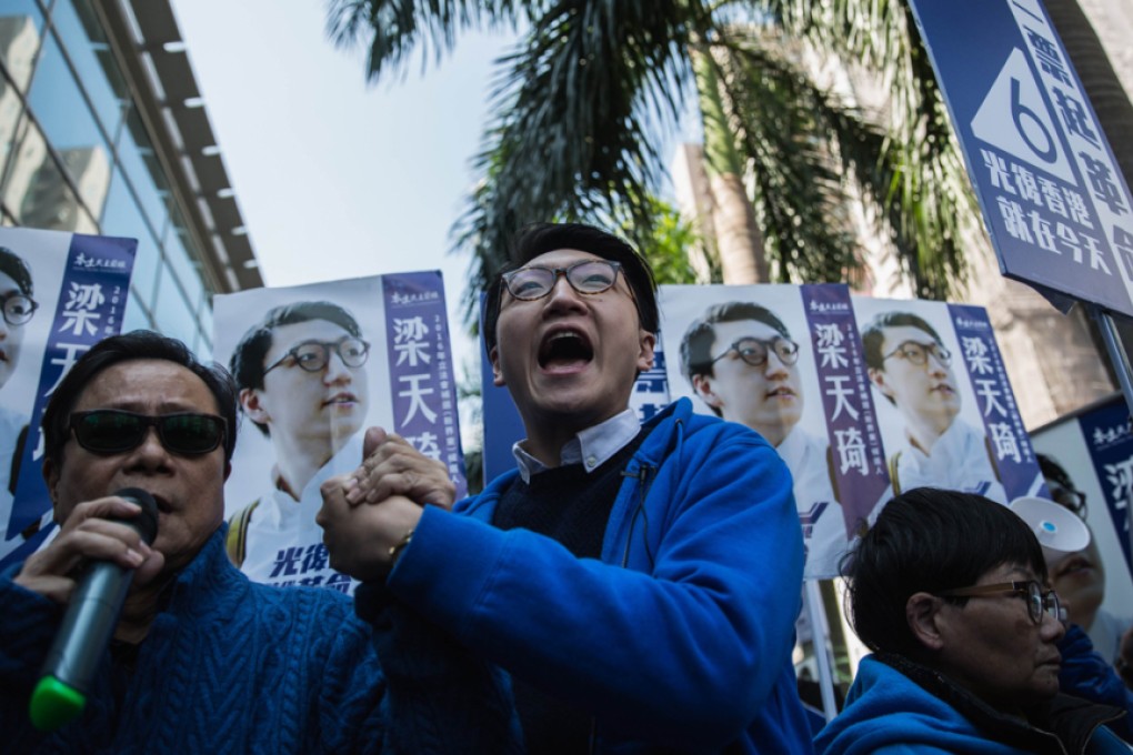 Hong Kong activist Edward Leung (centre), one of the leaders of "localist" group Hong Kong Indigenous, shouts slogans as he campaigns next to his endorser, local lawmaker Raymond Wong (left), during the New Territories East by-election in February. Photo: AFP