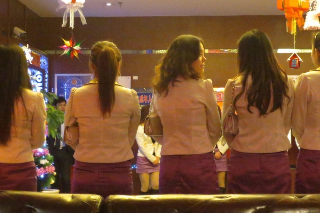 Hotel staff line up to welcome customers.