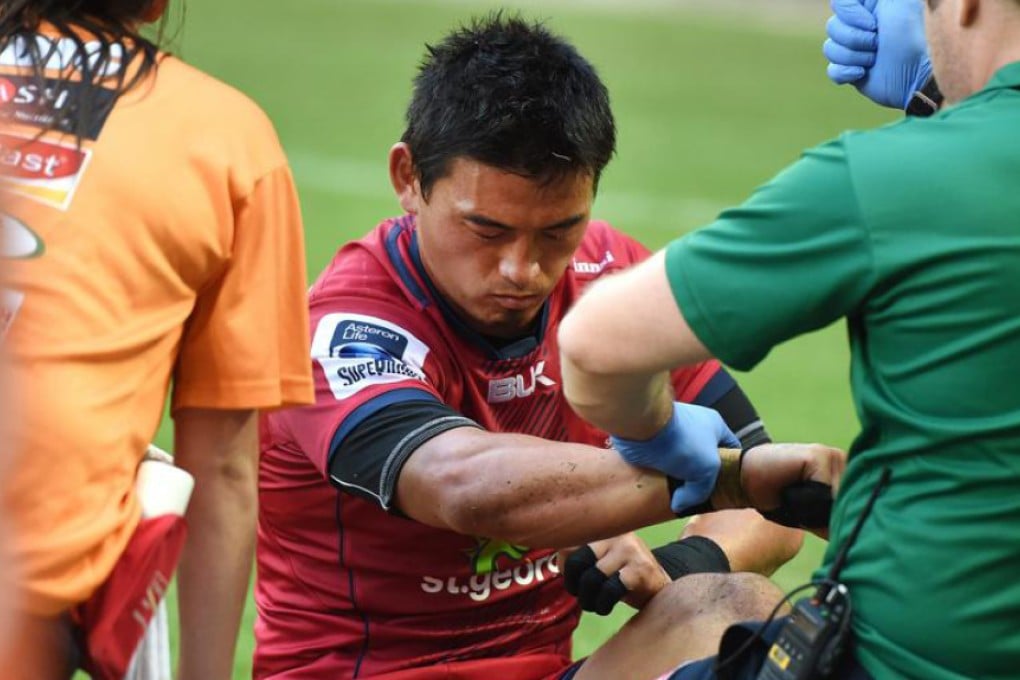Fullback Ayumu Goromaru is attended to by medical staff before going off injured midway through the second half of the Reds’ 35-25 Super Rugby victory over the Sunwolves on Saturday. Photo: EPA