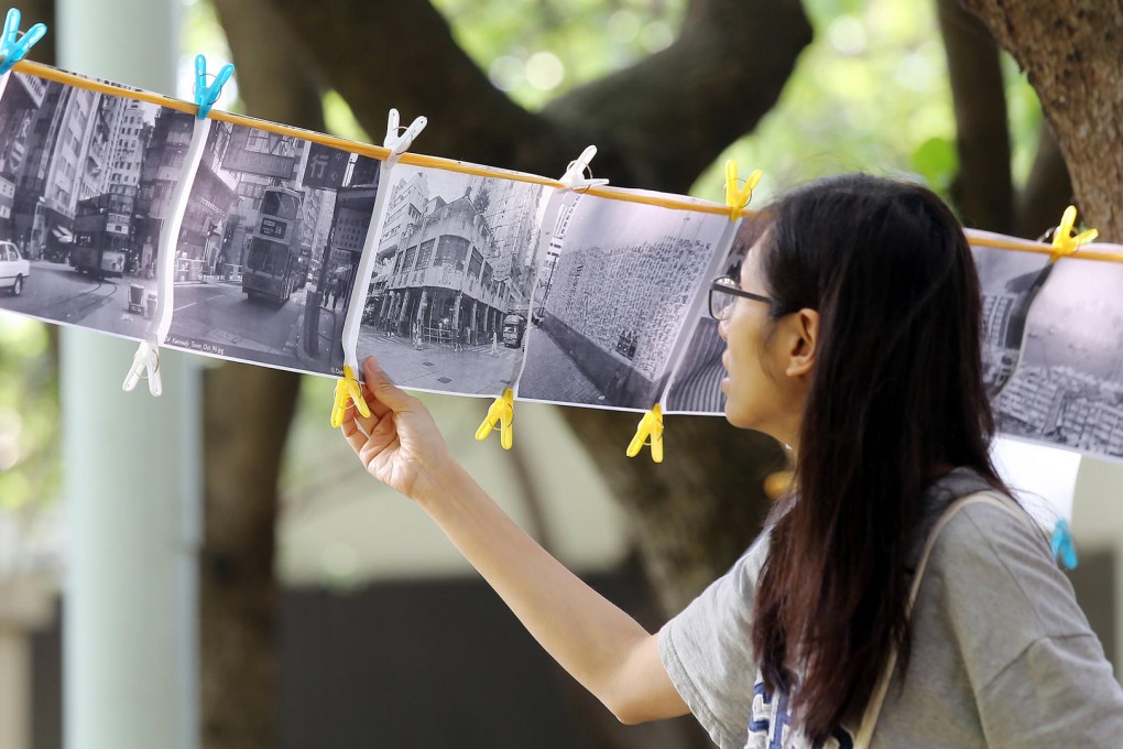 Residents pin up old photos of the area in Cadogan Street Temporary Garden as part of their battle to retain the green space. Photos: Fionnuala McHugh; SCMP