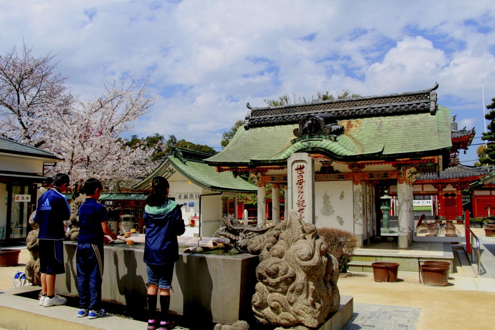 Children wash their hands at a purification basin at Kosanji Temple, in Ikuchijima. Photos: Angeles Marin Cabello