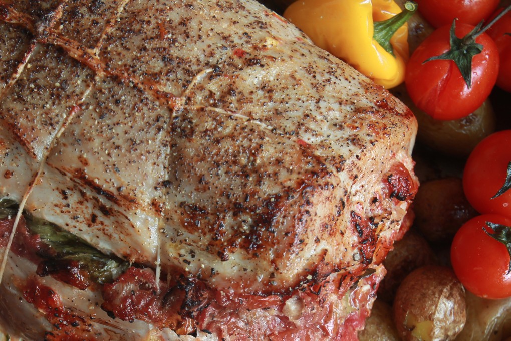 Pork rack stuffed with parmesan, fresh basil, roasted tomato and garlic. Photo: Jonathan Wong