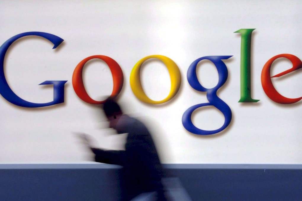 A man passes by a Google logo in Frankfurt, Germany. Photo: EPA/Boris Boessler