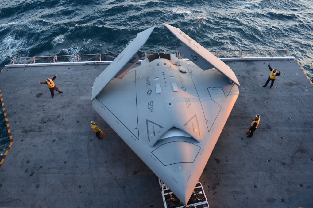 An X-47B demonstrator with folded wings on the aircraft elevator of USS George HW Bush in 2013. Photo: MC2 Timothy Walter