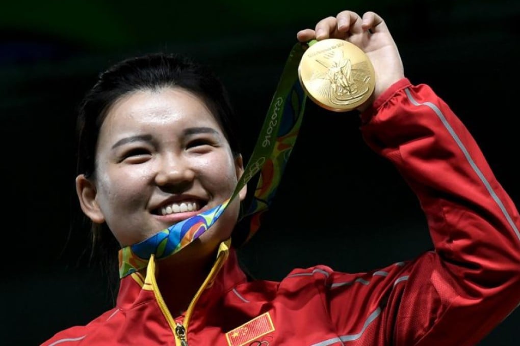 Gold medal winner Zhang Mengxue from China celebrates on the podium after taking the women’s 10m air pistol shooting event in Rio. Photo: AFP