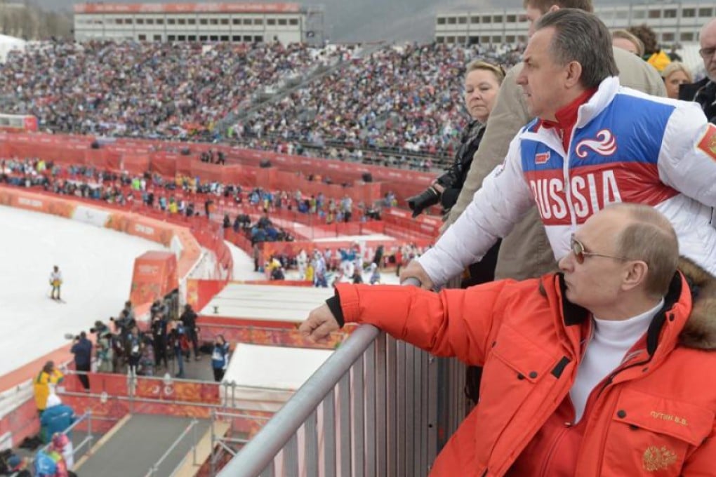 Russian president Vladimir Putin (seated) and sports minister Vitaly Mutko watch the downhill skiing competition at the 2014 Winter Paralympics in Sochi. Mutko vowed Sunday to fight Russia’s full ban from the 2016 Paralympics in Rio. Photo: AP