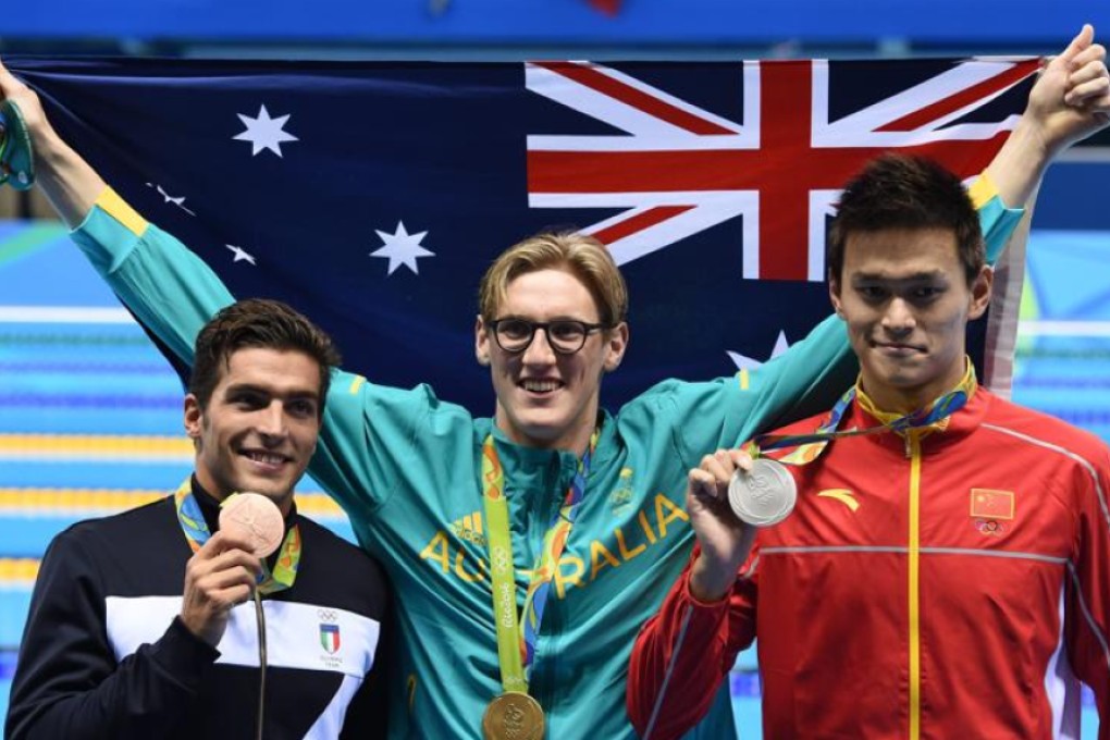 Gold medal winner Mack Horton of Australia (centre) poses for photographers with silver winner Sun Yang of China (right) and bronze winner Gabriele Detti of Italy after the men’s 400m freestyle final on Saturday. Photos: EPA