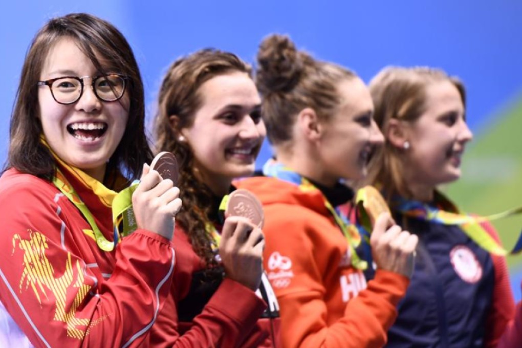 China’s Fu Yuanhui shows her joy after winning a bronze medal in the women’s 100m backstroke along with (left to right) equal bronze medal winner Kylie Masse (Canada), gold medal winner Katinka Hosszu (Hungary) and silver medallist Kathleen Baker (USA). Photo: AFP