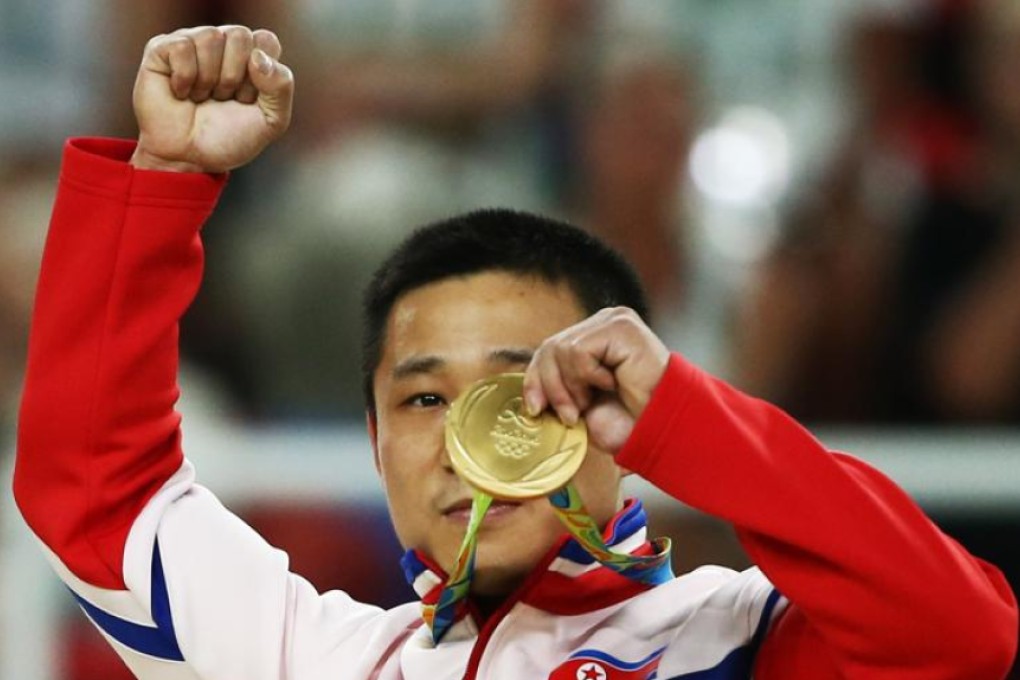 North Korea’s Ri Se-gwang celebrates after receiving the gold medal for his win in the men’s vault at the Rio Olympic Arena on Monday. Photo: Reuters