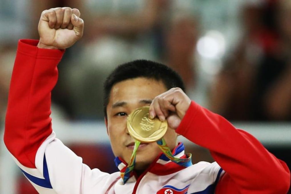 North Korea’s Ri Se-gwang celebrates after receiving the gold medal for his win in the men’s vault at the Rio Olympic Arena on Monday. Photo: Reuters