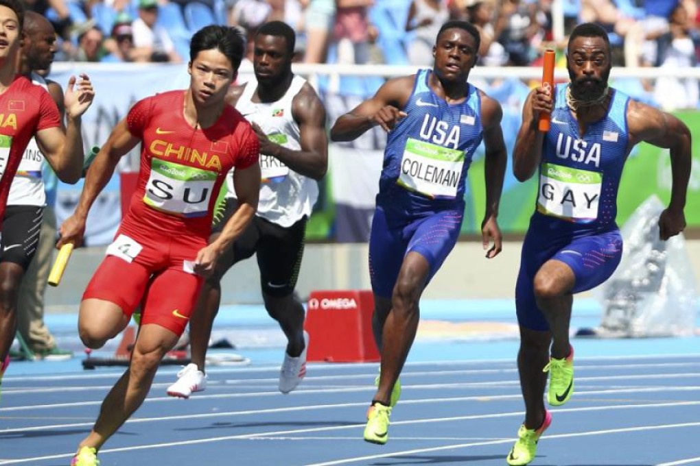Su Bingtian of China receives the baton from team-mate Xie Zhenye alongside American runners Christian Coleman and Tyson Gay. Photo: Reuters