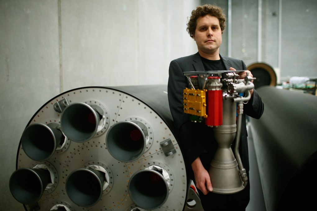 RocketLab CEO, Peter Beck poses with The Rutherford at the company's Auckland headquarters. The Rutherford, a battery-powered rocket engine printed on 3D parts, is set to reduce the cost for companies to send satellites to space by as much as US$45 million. Photo: Phil Walter/Getty Images