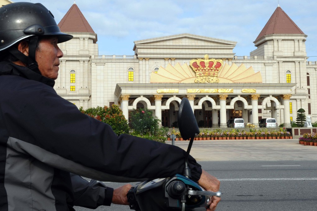 A motorbike taxi driver waiting for clients in front of the Crown Casino run by Silver Shores International Resort in the Vietnamese central coastal city of Danang. Photo: HOANG DINH NAM/AFP/Getty Images