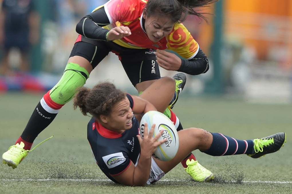 Hong Kong's Natasha Olson-Thorne is put under pressure by China at HKFC in the opening leg of the Asia Rugby Women's Sevens Series 2016. Photo: HKRU