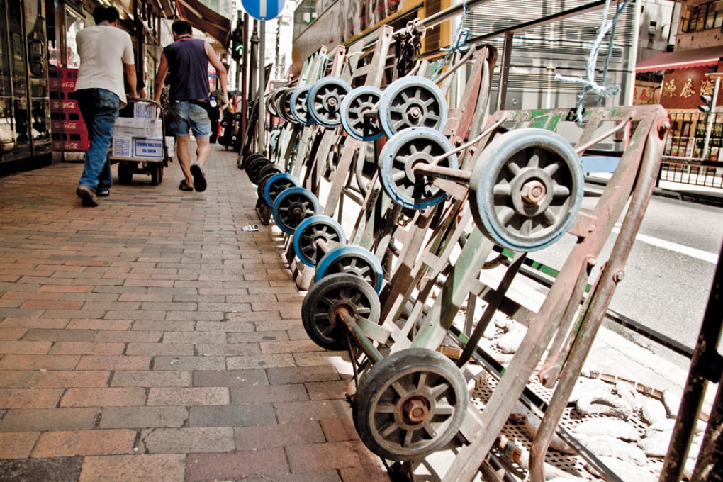 Trolleys blocking the sidewalks along Queen's Rd. West in Sheung Wan