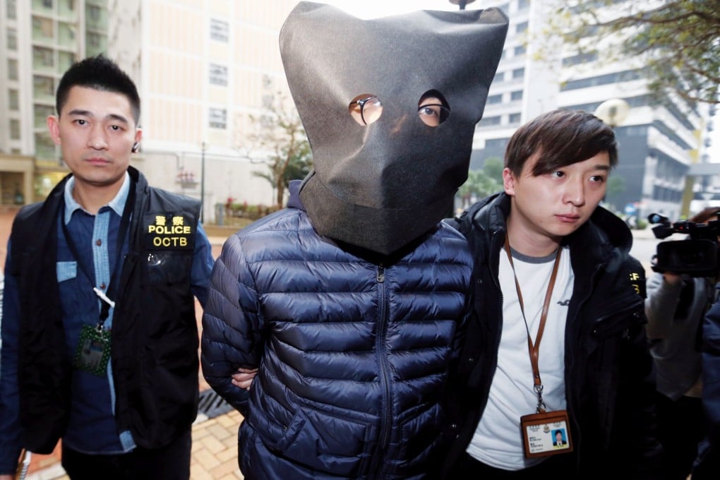 Bagged and tagged: A suspect is taken into custody. Photo: K.Y. Cheng/SCMP