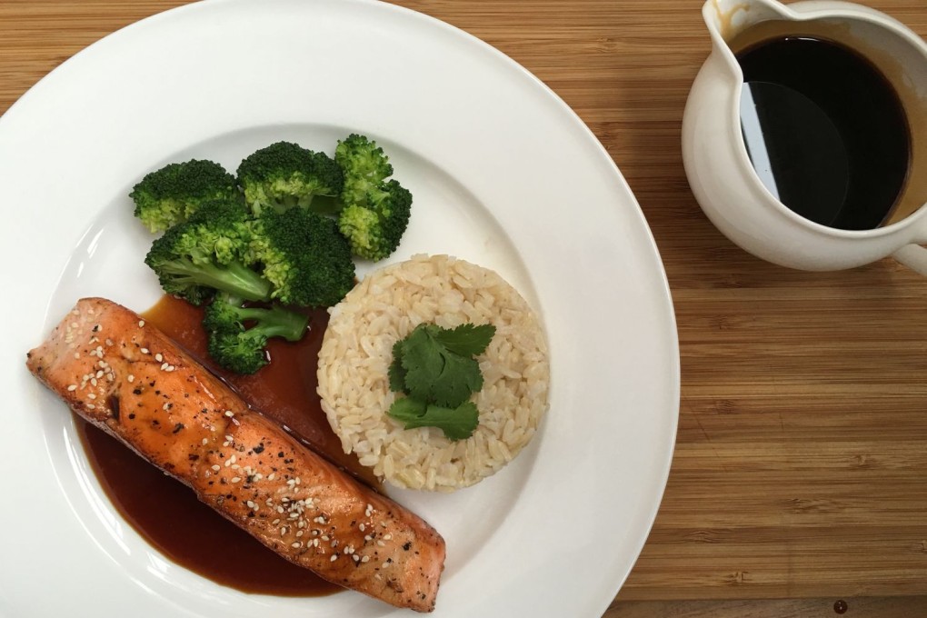 The salmon is scattered with sesame seeds and coriander leaves.