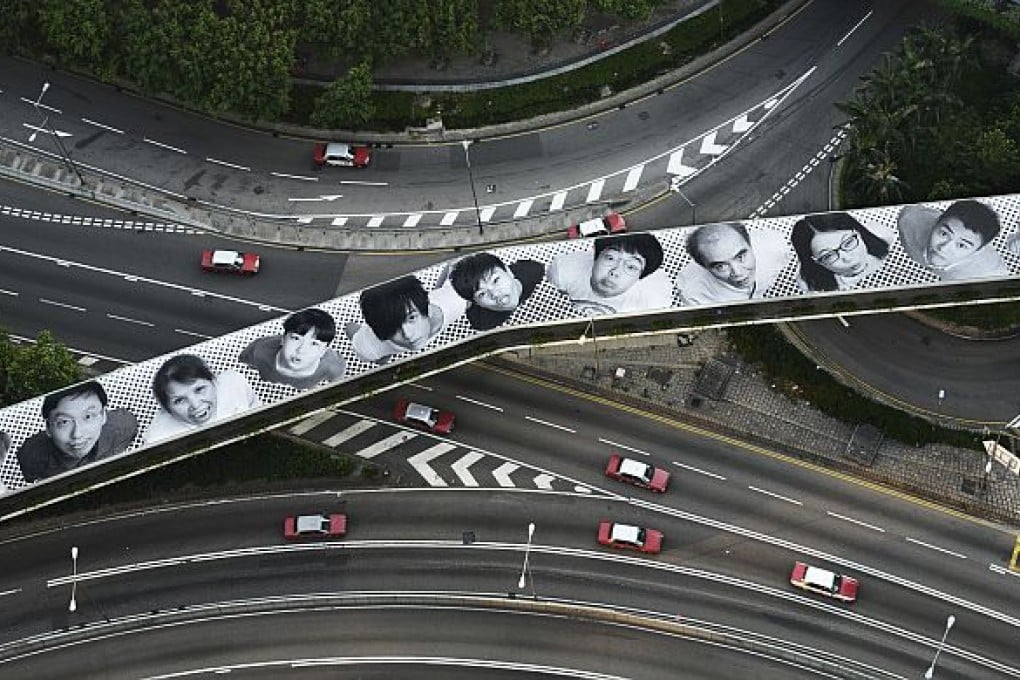 Artist JR Pays Homage To Hong Kong Atop a Footbridge In Central