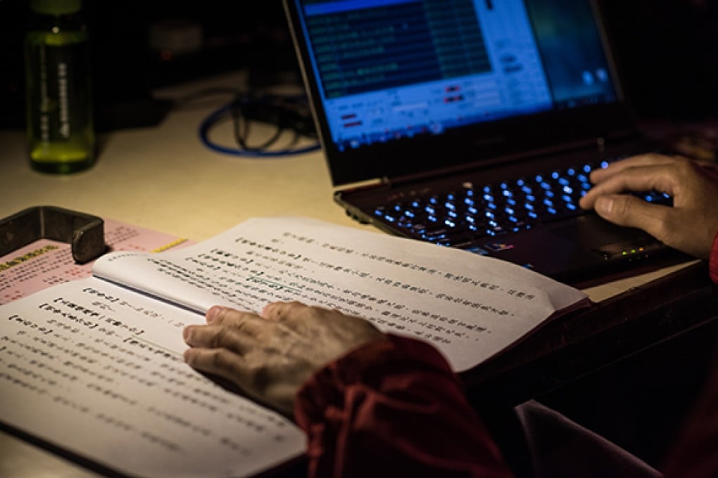 Backstage staff update surtitles by following along with the lyrics