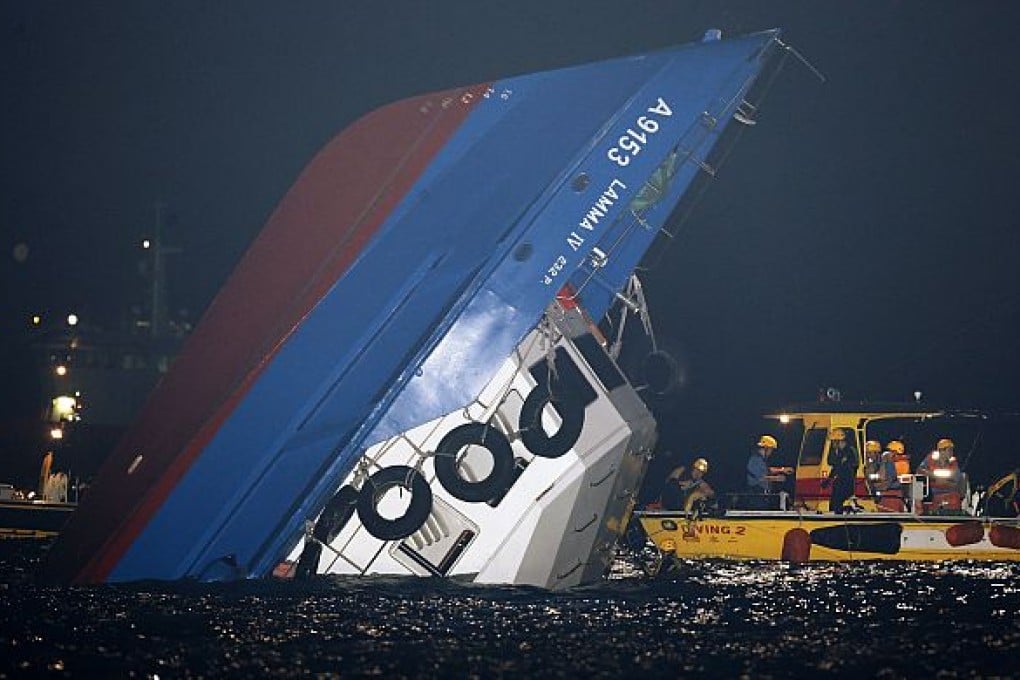 Rescuers reach the upturned ferry
