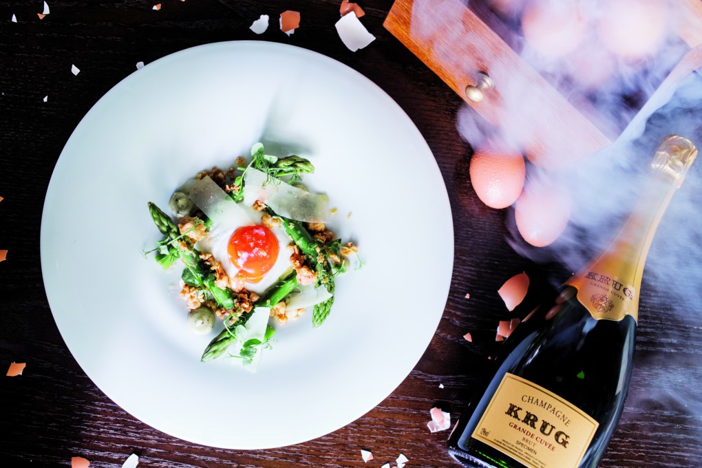 Ab Street Social's smoked egg and asparagus dish with a bottle of Krug.