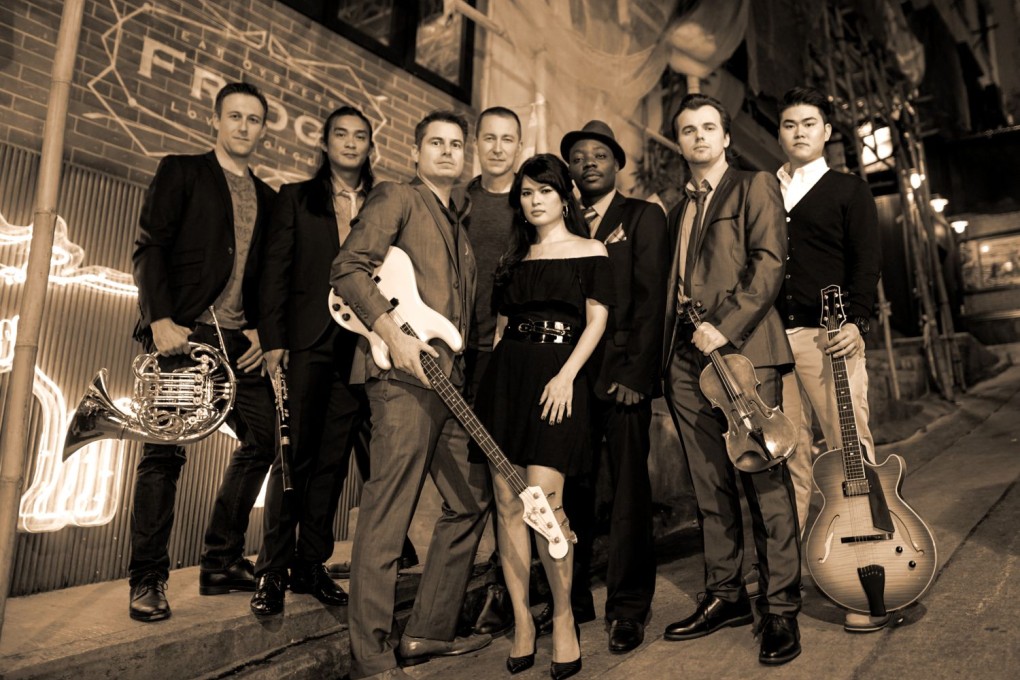 Ferrer, third from left, talks the band's upcoming unplugged session to raise funds for Save the Children. Photo: supplied