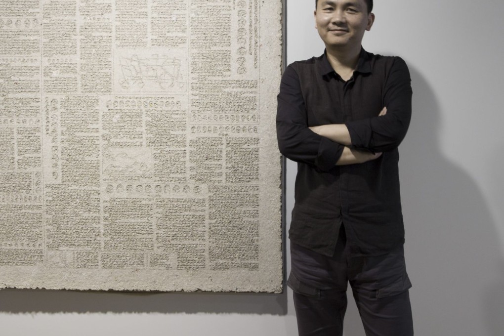 Zhang Zhenyu painstakingly glued specks of dust onto canvas. Photo: Yallay Gallery