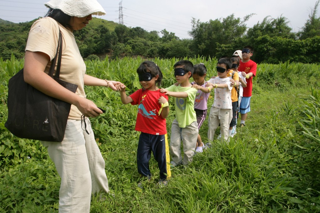 Students are taken on a blindfolded tour of the countryside near Tai Po to expose them to the sounds and smells of nature that are sadly missing in their everyday urban environment. Photo: Ricky Chung
