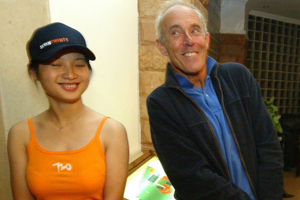 Surf competitor John Haynes jokes with the 720 China Surf Open promotion girl in the hotel in Shanwei during the 720 surfing competition in Cherry Point, Shanwei, China. Photo: Antony Dickson