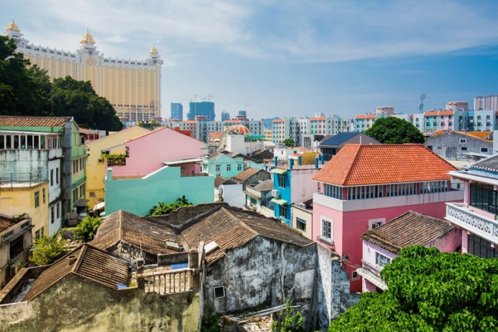 Galaxy Macau resort towers over Taipa Village in a juxtaposition of modernity and tradition.