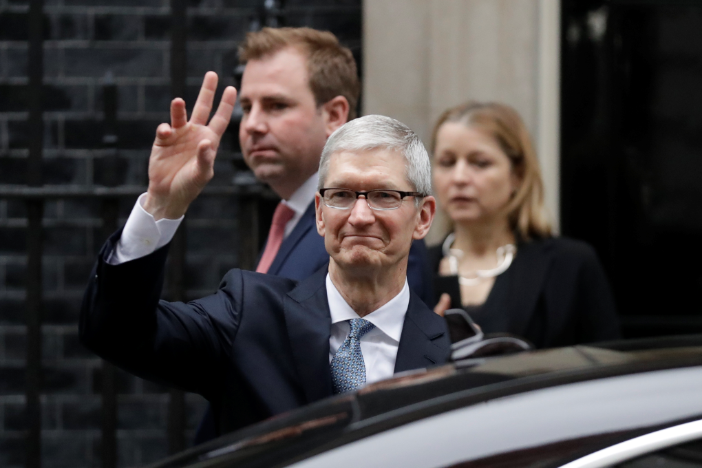 Apple CEO Tim Cook waves at members of the media as he leaves 10 Downing Street in London. Photo: AP/Matt Dunham