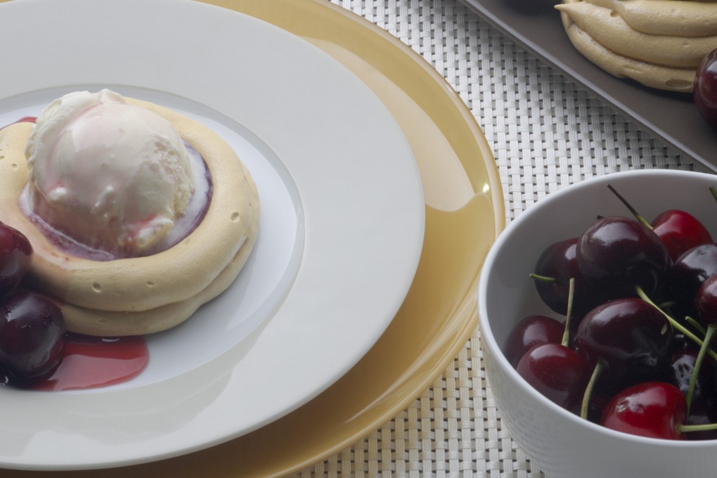 Brown sugar meringues with spiced brandied cherries and ice cream. Photo: Jason Bonello
