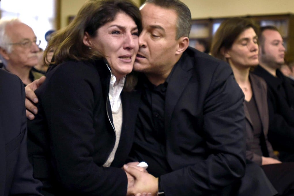 Gulcin and Celal Dede embrace after Markus Kaarma was found guilty of deliberate homicide in the death of their son. Photo: AP