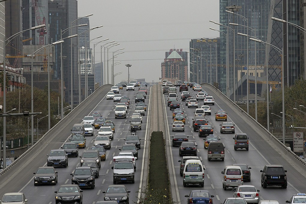 After the Olympics, Beijing implemented a controversial new rule that barred one-fifth of the city's private vehicles from the roads on weekdays, according to the last number on their licence plates. Photo: EPA