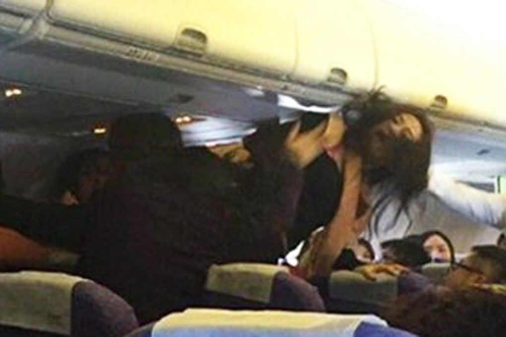 A woman is out of her seat with her hair flailing during the brawl. Photo: SCMP pictures