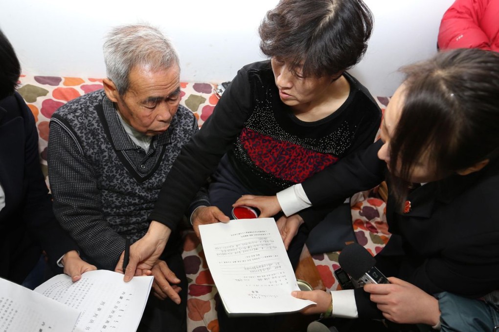 Hugjiltu's parents (centre) receive the verdict in Hohhot, Inner Mongolia. Photo: AFP