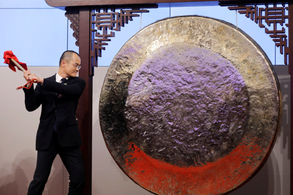 Wang hitting the Chinese gong at the Hong Kong Stock Exchange. (Picture: Reuters)