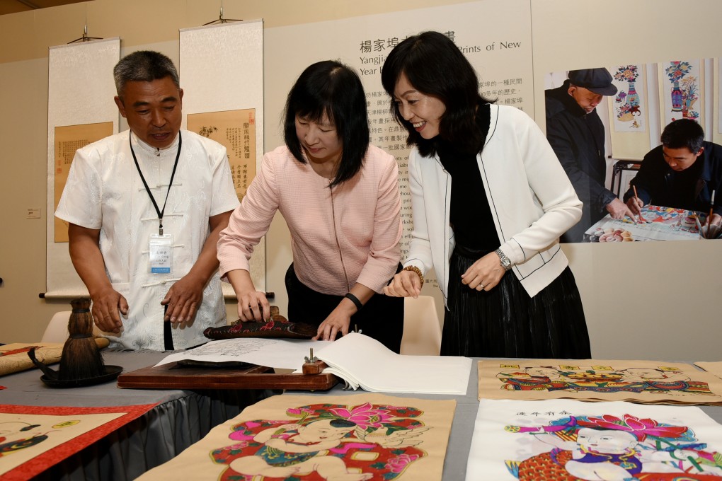 Demonstration of Yangjiabu Woodblock Prints of New Year Paintings: Zhao Xintian (right), deputy curator of the Shandong Provincial Cultural Center, and Yang Naidong (left), an intangible cultural heritage bearer of Yangjiabu woodblock prints of New Year Paintings, introducing the art to Michelle Li (centre), Director of Leisure and Cultural Services.