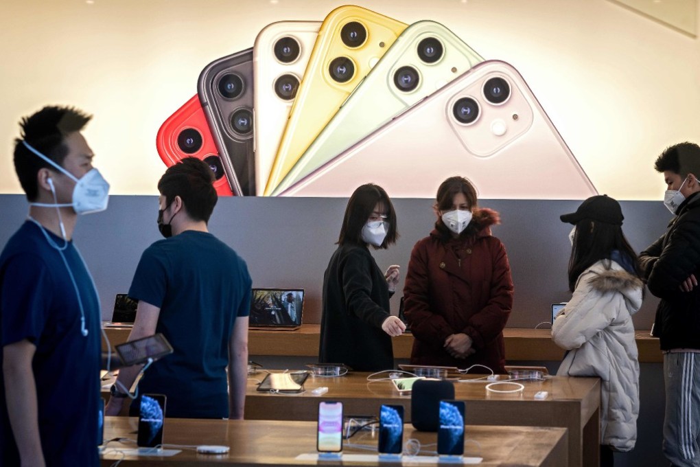 Staff and customers wearing face masks at an Apple Store in Beijing on February 22. (Picture: AFP)
