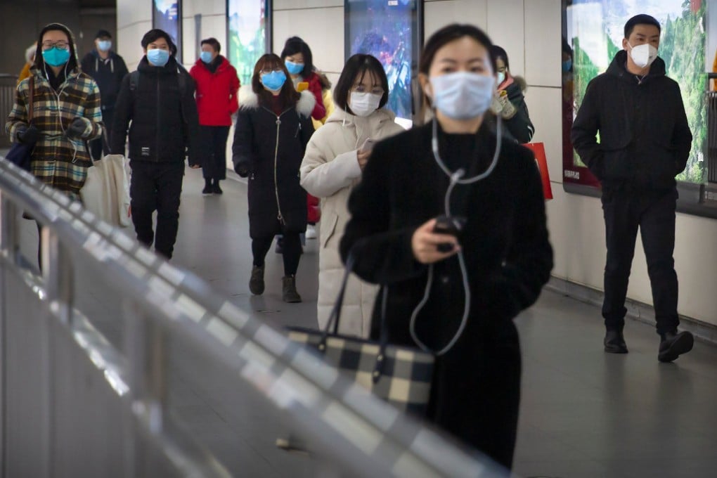 Passengers with face masks on in a Beijing subway station on March 6. (Picture: AP)