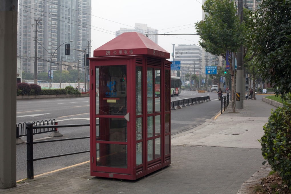 An old telephone booth in a street in Shanghai on July 5, 2019. (Picture: Fernando Garcia Esteban/Shutterstock)